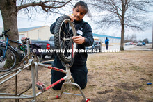 Nebraska Engineering’s Alejandro Marquez works on removing a tire from a donated ride at the Linco