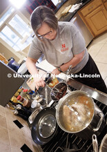 Sherri Jones, dean of college of education and human sciences, makes tamales in her home kitchen. Sh