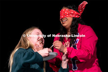 Ana Raymundo, right, feeds Abby Post pudding while being blindfolded during the OASIS and FRATERNITY