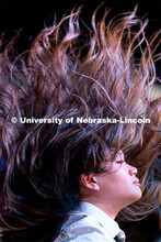 A member of Delta Phi Lambda flips their hair during the OASIS and FRATERNITY AND SORORITY LIFE Stro