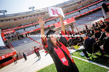 Isabel Adrover Gallego waves to family and friends after receiving her diploma. Undergraduate commen