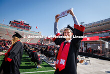 Chase Wolgamott waves to family and friends after receiving his College of Business degree. Undergra