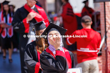 Grad blows a kiss. Undergraduate commencement at Memorial Stadium. May 20, 2023. 