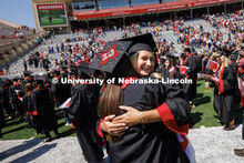 Jacqueline Wollschlaeger, right, hugs her friend, Ashley Oltman following commencement. Undergraduat
