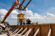 Concrete is poured into a barrier being tested at the Midwest Roadside Safety Facility for the State