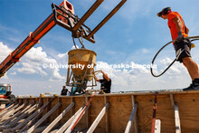 Concrete is poured into a barrier being tested at the Midwest Roadside Safety Facility for the State