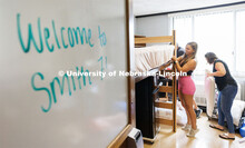 Carmela VanZyl fixes the corner of her mattress pad as she moves into her Smith Residence Hall room 