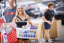 Carley Schroeder of Omaha carries the last of her belongings into Smith Hall. Sunday early arrival m