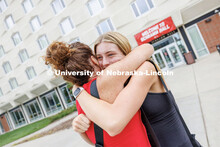 Brielle Staines of Overland Park, Kansas, hugs her mom, Stephanie, outside Schramm Hall. Sunday earl