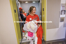 Abby McFarland carries the last of her clothes off the elevator toward her Smith Residence Hall room