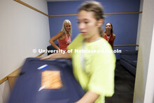 Paige Thompson of Norfolk, left, and Kate-Lynn McNamara of Grand Island watch as their belongings ar