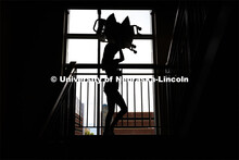 Krista Hoy of Fargo, North Dakota, is silhouetted against the windows as she carries her sister’s 