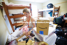 Sydney Perkins of Chaska, Minnesota, unpacks her room in University Suites. Sunday early arrival mov