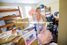 Sydney Perkins of Chaska, Minnesota, clears out some of her emptied bags while unpacking her room in