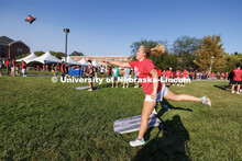 Maddy Tubrick of Omaha makes a leaping toss in corn hole. Chancellor’s BBQ in the green space betw