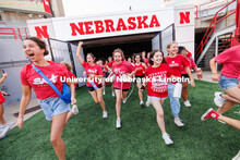 Students charge out of the gates at the Tunnel Walk. Tunnel Walk in Memorial Stadium. August 18, 202