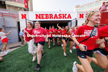 Students charge out of the gates at the Tunnel Walk. Tunnel Walk in Memorial Stadium. August 18, 202
