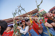 Maggie Norris (red hat), Jaiden Davis and Peyton Kullman go full corn as they cheer on the cornhuske