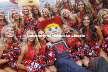 Herbie Husker poses with the Scarlets dance team. Northern Illinois football in Memorial Stadium. Se