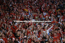 Husker fans light up the night during the light show between the 3rd and 4th quarters. Northern Illi