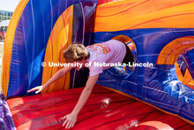 Brady McGerr races through an inflatable obstacle course at Hanging with the Huskers event. Septembe