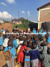 Lydia Storm, center, and Zoey Armstead, both seniors in biochemistry, are surrounded by Rwandan scho