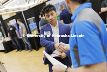 Francisco Becerra, a junior in construction management, talks with a representative from ISEC. Unive