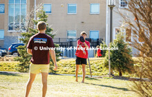 Beta Theta Pi Fraternity brothers play catch in front yard of their Fraternity house. February 20, 2