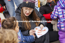 Mollie Von Kampen talks with the children as they prepare to give appreciation hearts to the food se
