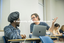 Tristian Swift (left) a Junior English major talks about his final project with Professor Richard Gr