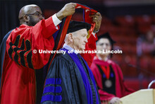 Larry Johnson is hooded by Chancellor Rodney D. Bennett after Johnson has awarded an honorary degree