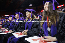 Emma Schlenkerand and Christina Schauer listen to final comments by Dean Richard Moberly after they 