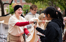 ASUN Student Government co-chair, Lily Rippeteau, hands out t-shirts to student volunteers before th