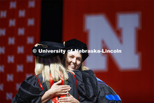 Nicole Weyers is hugged by Professor Stacie Ray after she received doctor of audiology hood. Graduat