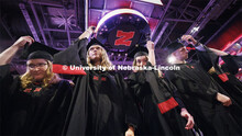 Kimberly Osborn, Kaylee Pekarek, Lisa Peterson and Scott Peterson move their tassels at to celebrate