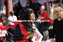 Divyn Williams waves to family and friends after receiving her degree from the College of Business. 