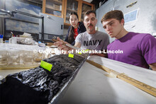 Doctoral student Jim Benes points out the layers of soil deposited in a core sample from Nebraska’
