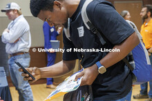 Oluwafunmibi Fasanya, a Statistics Graduate Student, snaps a picture of a QR code at the East Campus