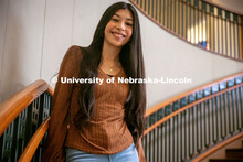 Rubi Hernandez Ochoa, a sophomore Advertising and Public Relations major, leans against the stairs i