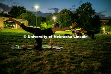 Students participating in Outdoor Glow in the Dark Yoga at the Meier Commons Green Space. September 