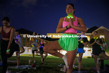 Students participating in Outdoor Glow in the Dark Yoga at the Meier Commons Green Space. September 
