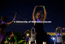 Students participating in Outdoor Glow in the Dark Yoga at the Meier Commons Green Space. September 