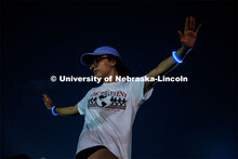 Students participating in Outdoor Glow in the Dark Yoga at the Meier Commons Green Space. September 