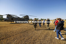 UNL advisors and professors walk to the CH-47D Chinook helicopter to observe the ROTC cadets on fall