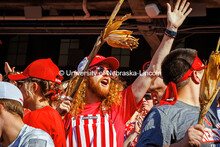 Husker Fans hold stalks of corn at the Nebraska vs Rutgers football game. Homecoming game. October 5