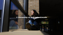 Hana Pham, a first-year law student, appears to be looking at her reflection as she glances outside 