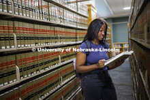 A law student studies in the stacks of the library. College of Law photoshoot. October 10, 2024. 