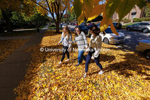 Emily Hodgin (left), Riley Bruno and Natalie Altenhoff walk through newly-fallen leaves on city camp