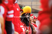 One fan dressed up in the Scream costume while wearing a corn head hat at the Nebraska vs UCLA footb