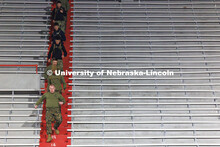 Captain Brian Garretson leads a group of NROTC members down a flight of stairs. Navy and Marine Corp